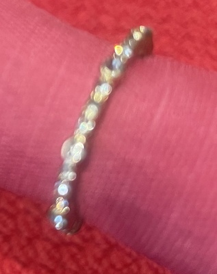 Silver ring, adjustable size, with heart shaped white crystals at both ends.