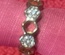 Adjustable Gold Ring, white crystals, band perforated with holes.  Size 6.