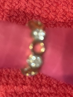 Adjustable Gold Ring, white crystals, band perforated with holes.  Size 6.