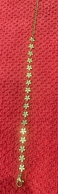 Gold Bracelet with multiple tiny flowers each with a turquoise stone center