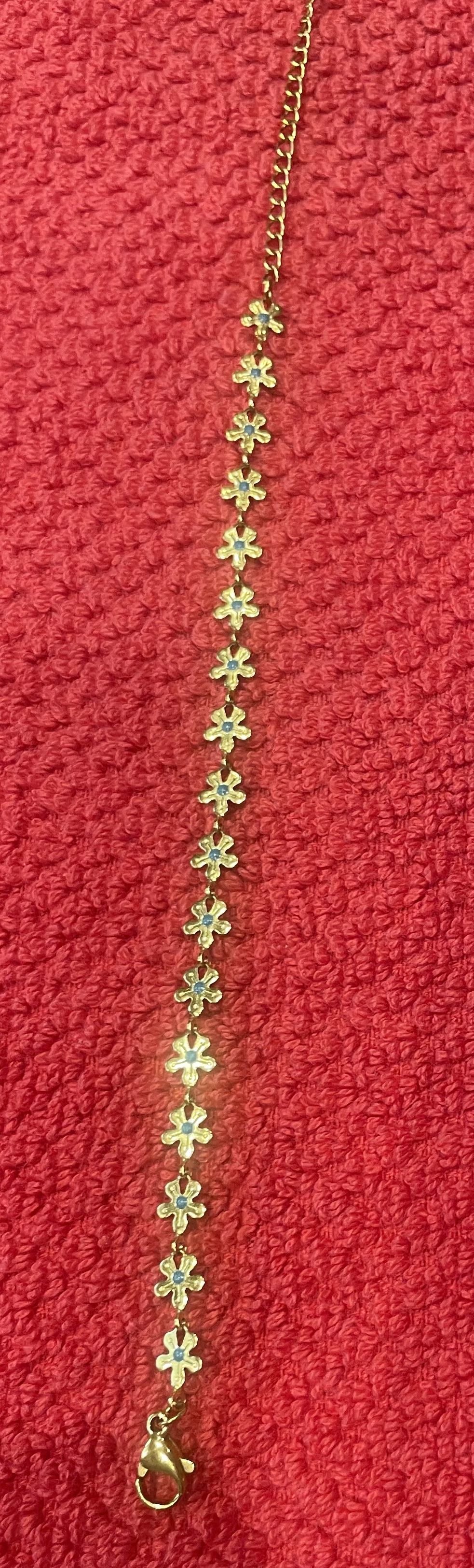 Gold Bracelet with multiple tiny flowers each with a turquoise stone center